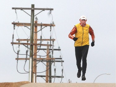 Marathon runner Martin Parnell jogs along the Bow River pathway near his Cochrane home Tuesday  December 8, 2015. He is hosting his 6th annual fundraising run in the town December 31. Last year he suffered a blood clot in his brain which nearly killed him.