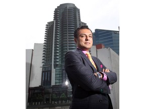 Riaz Mamdani, CEO of the Strategic Group, stands in front of the rendering of the group's highrise project on the site at 10th Avenue S.E. at 1st Street.