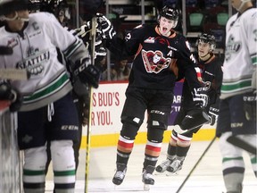 Travis Sanheim of the Calgary Hitmen slaps hands at the bench after a goal against the Seattle Thunderbirds in a game last month. He's aiming to make Team Canada's world junior team this year after being a late cut a year ago.