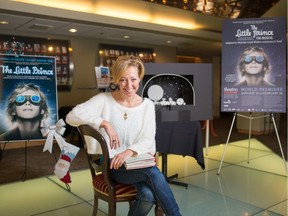 Theatre Calgary set and costume designer Bretta Gerecke with a copy of Antoine de Saint-Exupery's novel The Little Prince.