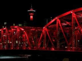 The Langevin Bridge and Calgary Tower are lit red Sunday evening to recognize the National Day of Remembrance and Action on Violence Against Women.