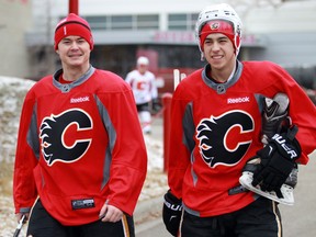 Calgary Flames forwards Jiri Hudler, left, and Johnny Gaudreau walk back to the Scotiabank Saddledome on Monday following practice at the Corral.