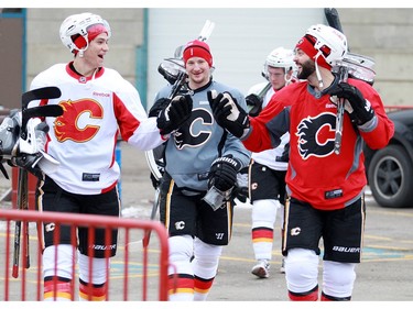 Joe Colborne left, Ladislav Smid (grey), and Brandon Bollig (red) head back to the Saddledome after the Flames practiced at the Corral on December 14, 2015.