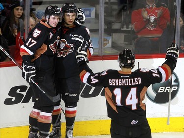 Hitmen Jordy Stallard, 17, Carsen Twarynski, 24 and Layne Bensmiller, 14, celebrate Twarynski's goal in the first period as the Calgary Hitmen hosted the Medicine Hat Tigers in Western Hockey League action at the Saddledome on Saturday, December 19, 2015.