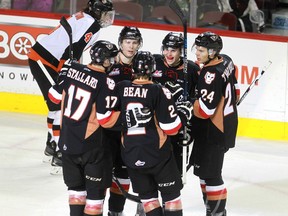 Jordy Stallard, 17, left; 9  Pavel Karnaukhov, 9; Jake Bean, 2, Jakob Stukel,10; and Carsen Twarynski, 24, celebrate a goal as the Calgary Hitmen hosted the Medicine Hat Tigers in Western Hockey League action at the Saddledome on Saturday, December 19. The Hitmen showed little rust after a Christmas break with a 4-0 drubbing of the Kootenay ICE on Sunday.