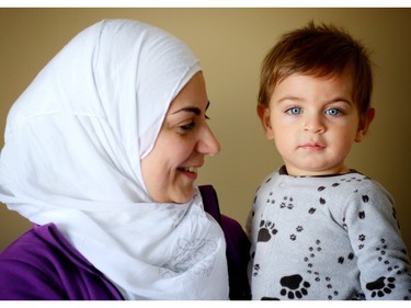 Nour, a Syrian refugee, and her 10 month old son Kareem enjoy their new home in Calgary.