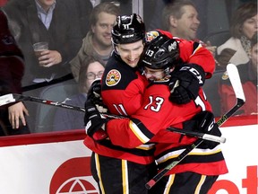 Calgary Flames star Johnny Gaudreau, right, celebrates his third goal of the game against the Winnipeg Jets, with teammate Mikael Backlund at the Scotiabank Saddledome on Tuesday night. The Flames won 4-1 for their 10th home victory in a row, tying a franchise record.