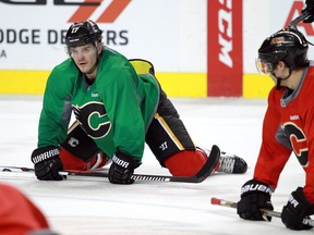 Centre Lance Bouma stretches out at the end of practice as the Calgary Flames took to the ice at the Saddledome on Sunday.