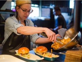 Jessica Pelland, executive chef at Charbar, prepares lunch at the restaurant at the Simmons Building in Calgary.