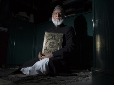 Imam Syed Soharwardy, chairman of the Al-Madinah Calgary Islamic Assembly, founder and president of the Islamic Supreme Council of Canada and a founding member of Muslims Against Terrorism, kneels on his prayer rug with a Quran at his home in Calgary, on November 10, 2015.