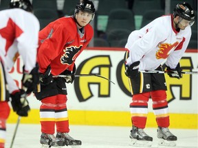 Calgary Flames centre Sam Bennett, left, waited for his turn to run  through drills during practice at the Scotiabank Saddledome on December 30, 2015.
