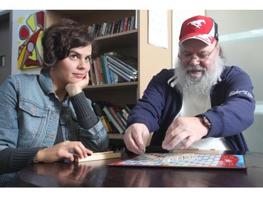 Alex Hupe lays down his letters during a game of Scrabble with volunteer Erica Bayley at the Alex Community Health Centre Wednesday October 28, 2015. Formerly illiterate, he says his life has been transformed by the centre, and now has learned how to read and write. The two get together to play a game of Scrabble every week.