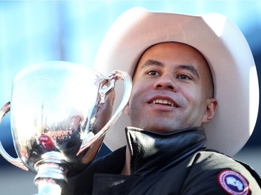 Calgary Stampeders Jon Cornish holds the Grey Cup during the Grey Cup Champions rally at City Hall in Calgary on December 02, 2014.