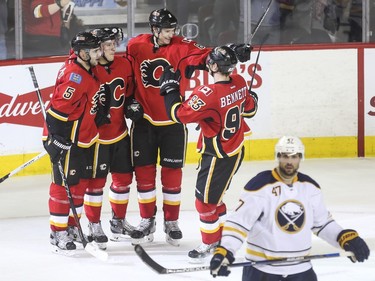 Calgary Flames Mark Giordano, Markus Granlund, Joe Colborne, and Sam Bennett celebrate the second goal of the game against the Buffalo Sabres at the Saddledome on Thursday.