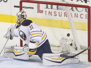Calgary Flames Markus Granlund puts the puck passed Buffalo Sabres goalie Chad Johnson for the second goal against the Buffalo Sabres at the Saddledome in Calgary, on December 10, 2015.