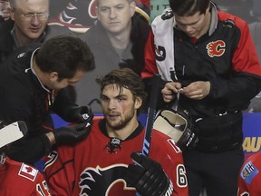 Calgary Flames forward Michael Frolik gets his face cleaned up after a check from behind from Buffalo Sabres' Cody Franson, during their Dec. 10 meeting. An injury in Tuesday's game in Nashville has sent Frolik back to Calgary for evaluation.