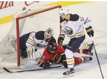 Calgary Flames David Jones gets tripped up as he headed for a breakaway during game action against the Buffalo Sabres at the Saddledome in Calgary, on December 10, 2015.