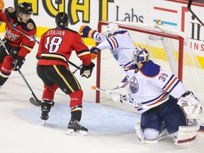 Calgary Flames centre Matt Stajan, centre, gets ready to make a short goal on the Edmonton Oilers at the Scotiabank Saddledome in Calgary on Sunday. The Flames won 5-3.