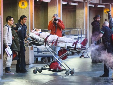 Patients are transported to hospital from the Calgary International Airport in Calgary on Wednesday, December 30, 2015.