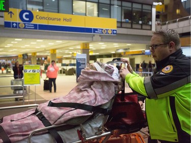 Patients are transported to hospital from the Calgary International Airport in Calgary on Wednesday, Dec. 30, 2015. (Aryn Toombs/Calgary Herald)