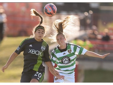 Seattle Sounders player Brianna Hooks, left, heads the ball at Stampeder Field in Calgary on Friday, June 19, 2015. The Foorhills WFC led the Seattle Sounders, 1-0, at the half in an exhibition game.