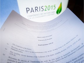 An illustration picture taken on December 10, 2015 in Paris shows a draft for the outcome of the COP21 United Nations conference on climate change next to the logo of the summit. Sleep-deprived ministers tasked with saving mankind from a climate catastrophe headed into a second night of non-stop talks Thursday, battling to overcome a rich-poor divide in search of a historic accord. Eleven days of UN talks in Paris have failed to achieve agreement on key pillars of the planned post-2020 climate pact, aimed at sparing future generations from worsening drought, flood, storms and rising seas.  / AFP / Belga / BENOIT DOPPAGNEBENOIT DOPPAGNE/AFP/Getty Images