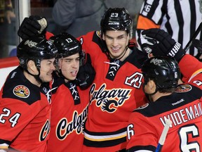 The Calgary Flames celebrate Johnny Gaudreau's second goal of the night against the Boston Bruins during the second period of NHL action at the Scotiabank Saddledome on Friday December 4, 2015.