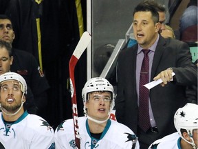 San Jose Sharks assistant coach Bob Boughner yells instructions during the first period of NHL action against the Calgary Flames at the Scotiabank Saddledome on Tuesday.