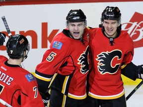 Calgary Flames from left, TJ Brodie, Mark Giordano, and Mikael Backlund celebrate Backlund's goal during the second period of NHL action against the San Jose Sharks at the Scotiabank Saddledome on Tuesday.