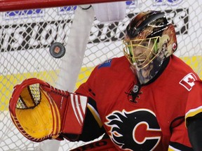 Jonas Hiller snatches the puck during a New York Ranger scoring chance in the the third period of NHL action in Calgary.