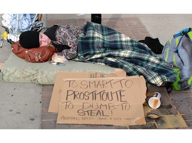 A young woman sleeps along 17th Avenue S.W. on Thursday October 29, 2015.