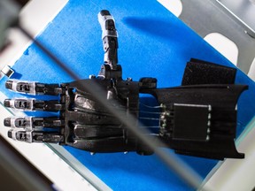 A 3D-printed hand is pictured at Colin Pischke's home office in Calgary.  Pischke has partnered with high school students across the province to 3D print and assemble custom-sized prosthetic hands for children in developing countries.