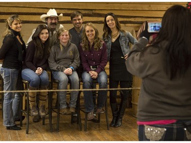 Jayda Differenz, 10, centre, gets her photos taken by her mother Jodi, with the cast of CBC's hit TV show, Heartland, including Jessica Steen (Lisa Stillman), from left, Alisha Newton (Georgie), Shaun Johnston (Jack Bartlett), Graham Wardle (Ty Borden), Amber Marshall (Amy Fleming), and Michelle Morgan (Lou Fleming) in support of HomeFront's 'Cool It, Calgary' campaign at the Symons Valley Ranch market in Calgary, on December 12, 2015.