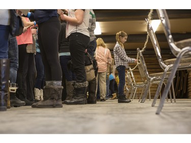 Reese Morse, 8, right, pops out of line to entertain herself a bit as she and hundreds of others wait in line to have their photos taken with the cast of CBC's hit TV show, Heartland, including Jessica Steen (Lisa Stillman), Alisha Newton (Georgie), Shaun Johnston (Jack Bartlett), Graham Wardle (Ty Borden), Amber Marshall (Amy Fleming), and Michelle Morgan (Lou Fleming) in support of HomeFront's 'Cool It, Calgary' campaign at the Symons Valley Ranch market in Calgary, on December 12, 2015.