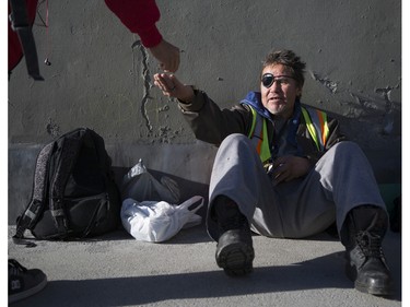 Bernie Jack, pan handles for money under the 9th Ave. N.W. bridge on 8th St. S.W. in Calgary, on November 22, 2015. Jack says he currently has a room to sleep in, but hasn't worked in years and considers himself a street person even though he has a roof over his head at night. Jack was also recently a victim of a brutal beating, to the point in which he had bones broken, had to have teeth removed, and he lost an eye and now wears a patch.