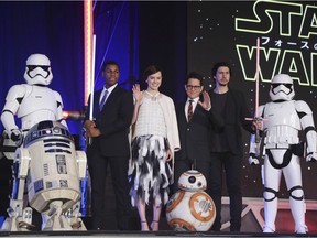 In this Thursday, Dec. 10, 2015 file photo, director J.J. Abrams, third right, and actors, John Boyega, second left, Daisy Ridley, third left, and Adam Driver, second right, pose for photos during the Japan Premiere of their latest film Star Wars: The Force Awakens in Tokyo. Advance ticket sales for the weekend opening of the film in Canada are already "unprecedented," reports Cineplex.