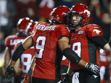 Calgary Stampeders' John Cornish, left, celebrates his touchdown with quarterback Bo Levi Mitchell during second half CFL football action against the B.C. Lions in Calgary, Friday, Sept. 18, 2015.THE CANADIAN PRESS/Jeff McIntosh