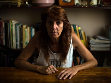 Karen Casey sits in her home on Edmonton Trail in Calgary on Wednesday, August 26, 2015. Casey, who has early onset Parkinson's and cervical cancer, is furious the City of Calgary has asked for her 18 year old son's financial information in order to receive a discounted recreation pass. "People look at me like I'm a junkie," says Casey on the rapid weight loss she's suffered from her diseases, and that she is trying to fix through fitness.