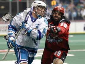 The Knighthawks' Cody Jamieson and Roughnecks defensman Mike Carnegie tangle during the first half of the Calgary Roughnecks vs Rochester Knighthawks Champion's Cup final in Rochester N.Y. on Saturday night, May 31, 2014.
