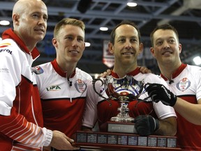 Kevin Koe, left, and his rink of Marc Kennedy, Brent Laing and Ben Hebert, celebrate winning the 2015 Home Hardware Canada Cup after defeating 2014 champ Mike McEwen 7-3 in the men's final on  Sunday  in Grande Prairie.