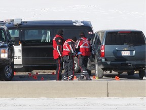 Police probe the scene after an officer-involved shooting left one man dead and a woman in critical condition on March 1, 2014.