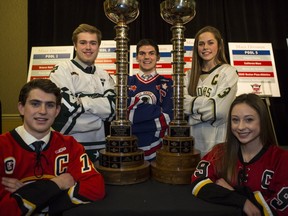 Markus Boguslavsky, from left, of Northwest Valley Flames, Brayden Dunn of Calgary North Stars, Cooper Johnson of  the Calgary Buffaloes, Nicolette Seper of Rocky Mountain Raiders and Jaslin Sawatzky of the Calgary Fire, pose by the men's and women's Mac's tournament trophies at Wednesday's news conference announcing the teams playing in this year's event.