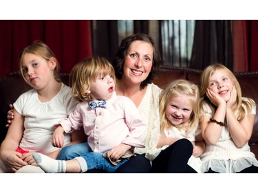 Hali Ludwick, a beast cancer survivor and a client of Made by Momma, sits in her home with her four children, Chloe, Benjamin, Jordan, and Taylor in Calgary on Thursday, November 12, 2015.