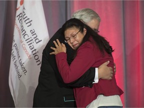 Commissioner Justice Murray Sinclair embraces residential school survivor Madeleine Basile after she spoke at the release of the final report of the Truth and Reconciliation commission, Tuesday in Ottawa.