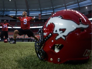 Calgary Stampeders' running back Jon Cornish (9) and running back Martell Mallett (34) stretch at the end of practice in Vancouver, B.C., on Wednesday November 26, 2014. The Calgary Stampeders and Hamilton Tiger-Cats are scheduled to play in the Canadian Football League's 102nd Grey Cup championship football game on Sunday.