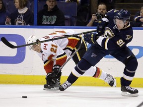 St. Louis Blues' Vladimir Tarasenko, of Russia, and Calgary Flames' Mason Raymond, left, chase after a loose puck during the second period of an NHL hockey game Saturday, Dec. 19, 2015, in St. Louis.