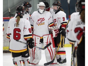 Calgary Fire goalie Katie Crowther is congratulated by teammates after their victory over the Edmonton Thunder in the opening female division game against Edmonton Thunder at the annual Macs Midget Tournament Boxing Day morning December 26, 2015 at Max Bell Arena.