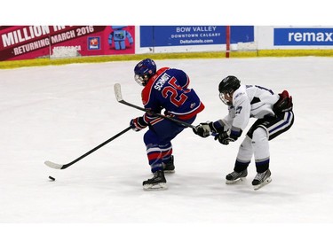 Pats Randen Schmidt tries to keep the puck ahead of Royals Shota Yamamoto as the Regina Pats Canadiens played the South Island Royals at the Mac's AAA Midget Hockey tournament on December 27, 2015 at the Max Bell arena.