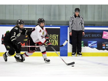 Raiders Nicolette Seper gets tangled up with Steelers LaShawn Vick as the Rocky Mountain Raiders  played the Lloydminster PWM Steelers on  December 27, 2015.