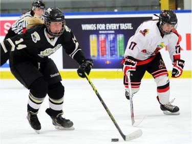 Raiders Kara Kondrat, 14, tries to get past Steelers Isabelle Lajoie as the Rocky Mountain Raiders  played the Lloydminster PWM Steelers on  December 27, 2015.